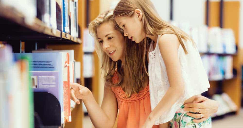 Selecting age-appropriate books can help foster a love of reading. Parents-Children-Reading-Shopping 3 Ways Parents Can Inspire Children to Love Reading | World Schools