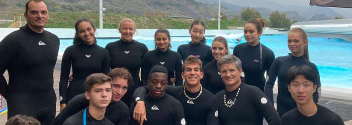 Latest news from TASIS - October, 2022 19 Diverse group of students and coaches at a swimming pool, representing World Schools sports programs.