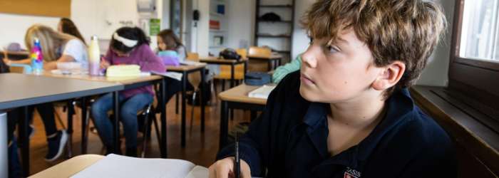 Latest news from TASIS - October, 2022 10 Engaged students studying in a modern classroom at World Schools for optimal education.