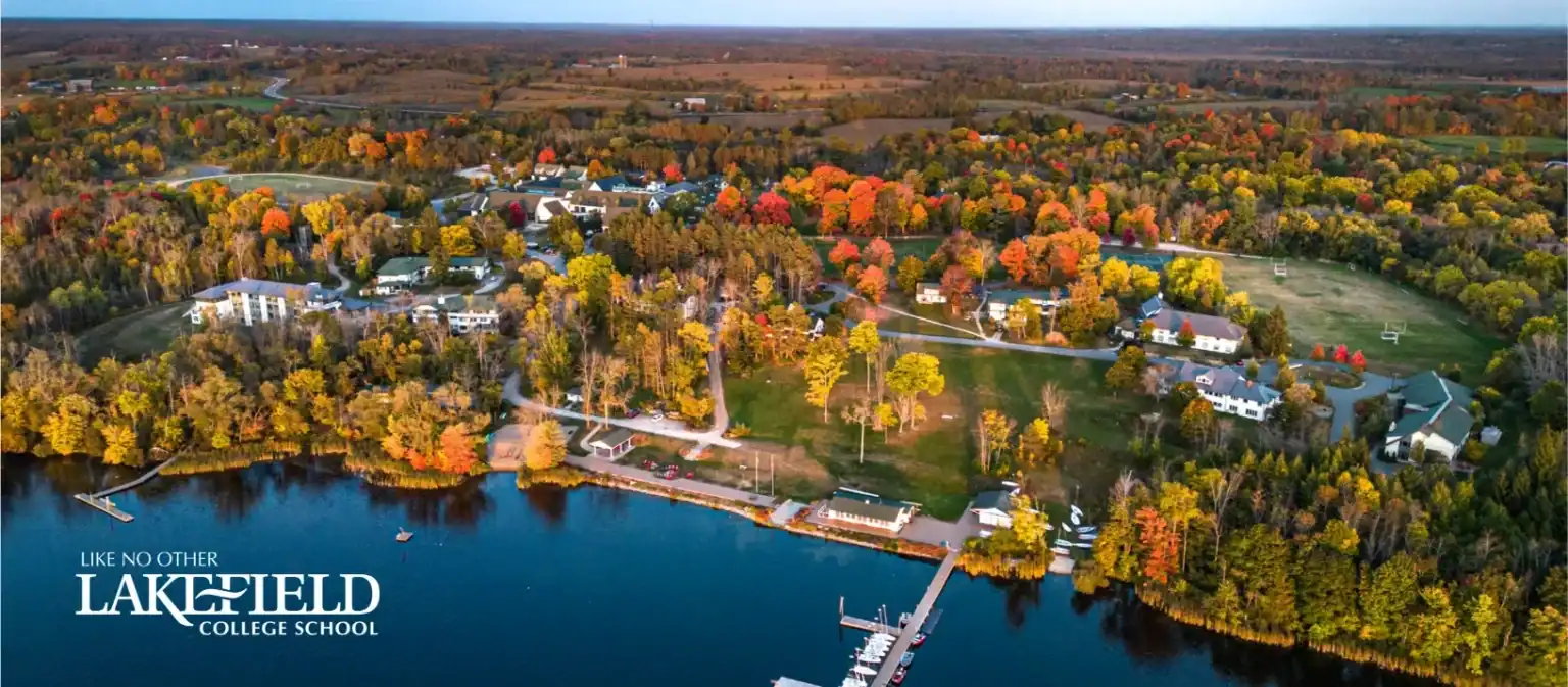 Aerial view of Lakefield College School surrounded by colorful fall foliage.