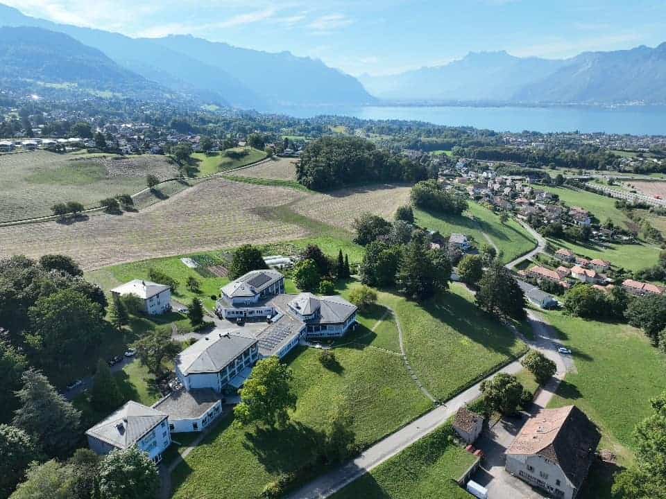 International school campus with scenic mountain and lake views.