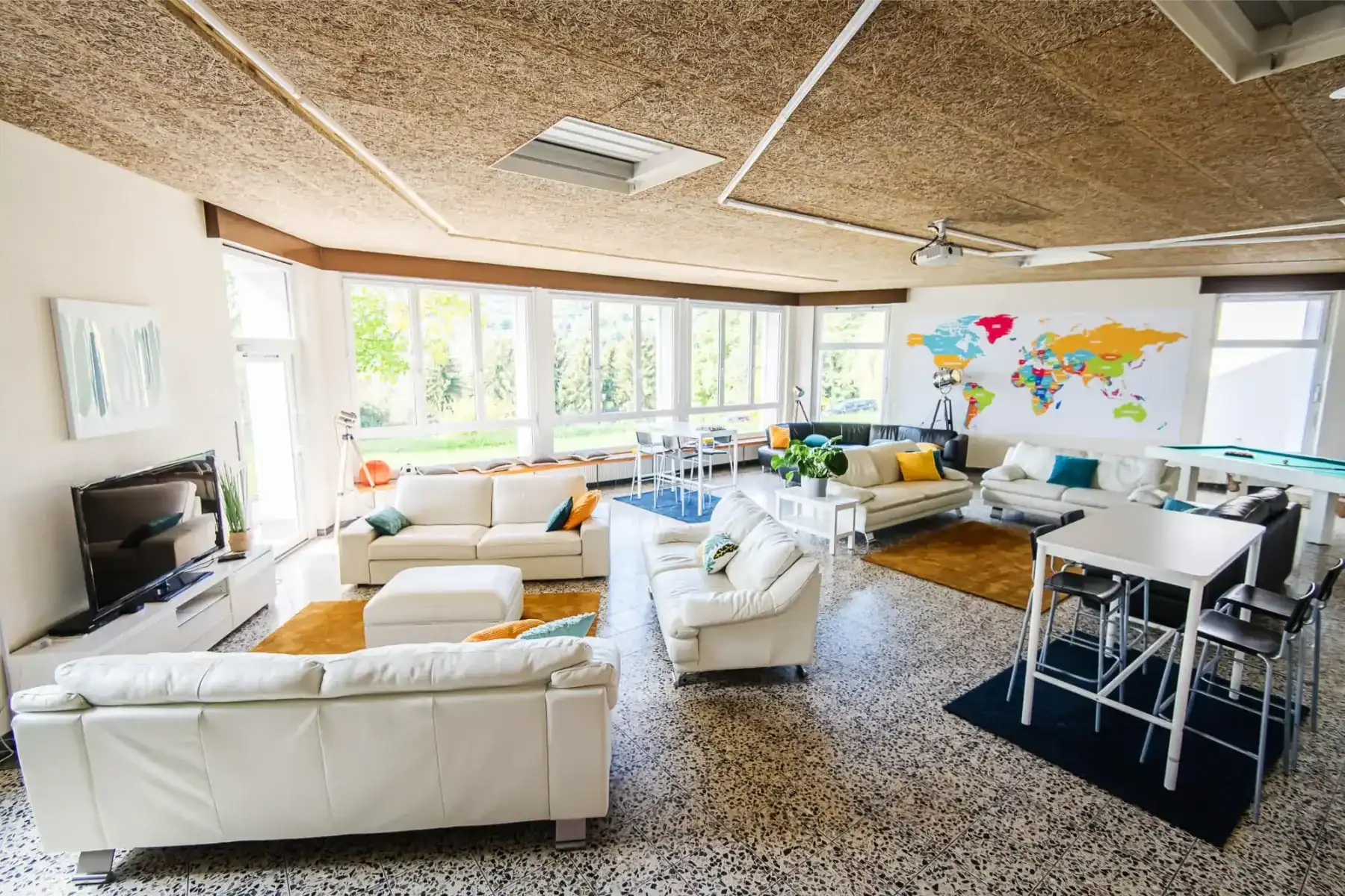 Bright lounge at Haut-Lac International Bilingual School with modern furniture and large windows.