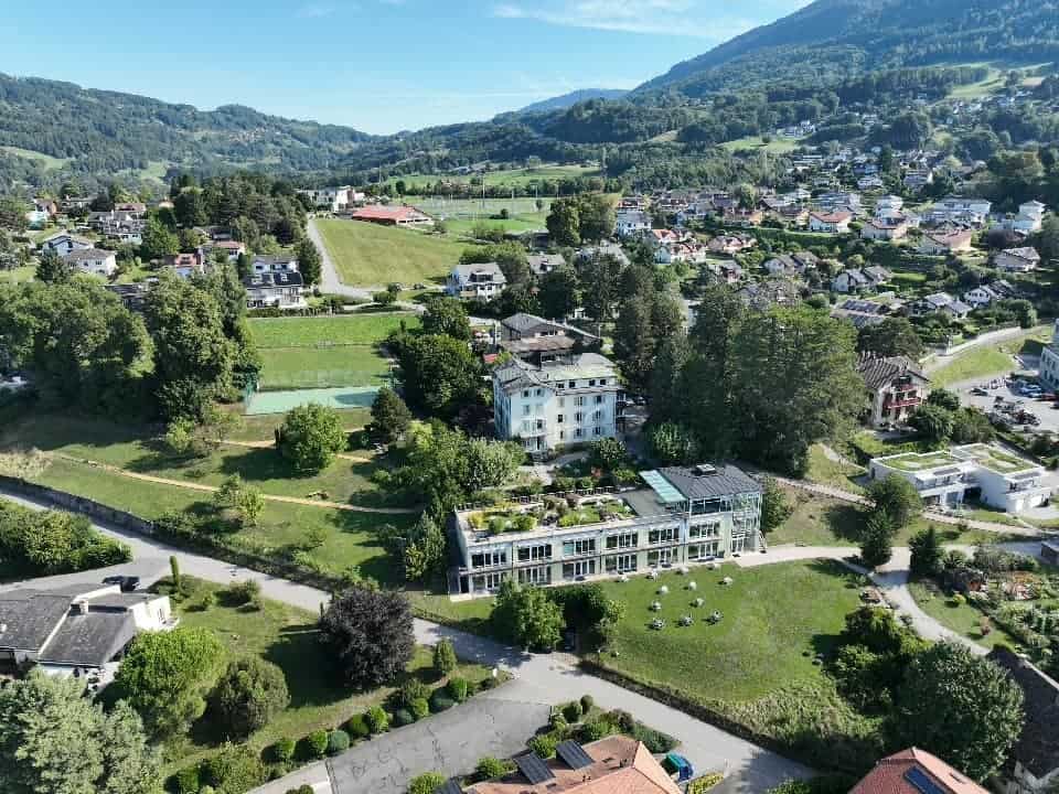 Aerial view of Haut-Lac International Bilingual School in a scenic mountain setting.