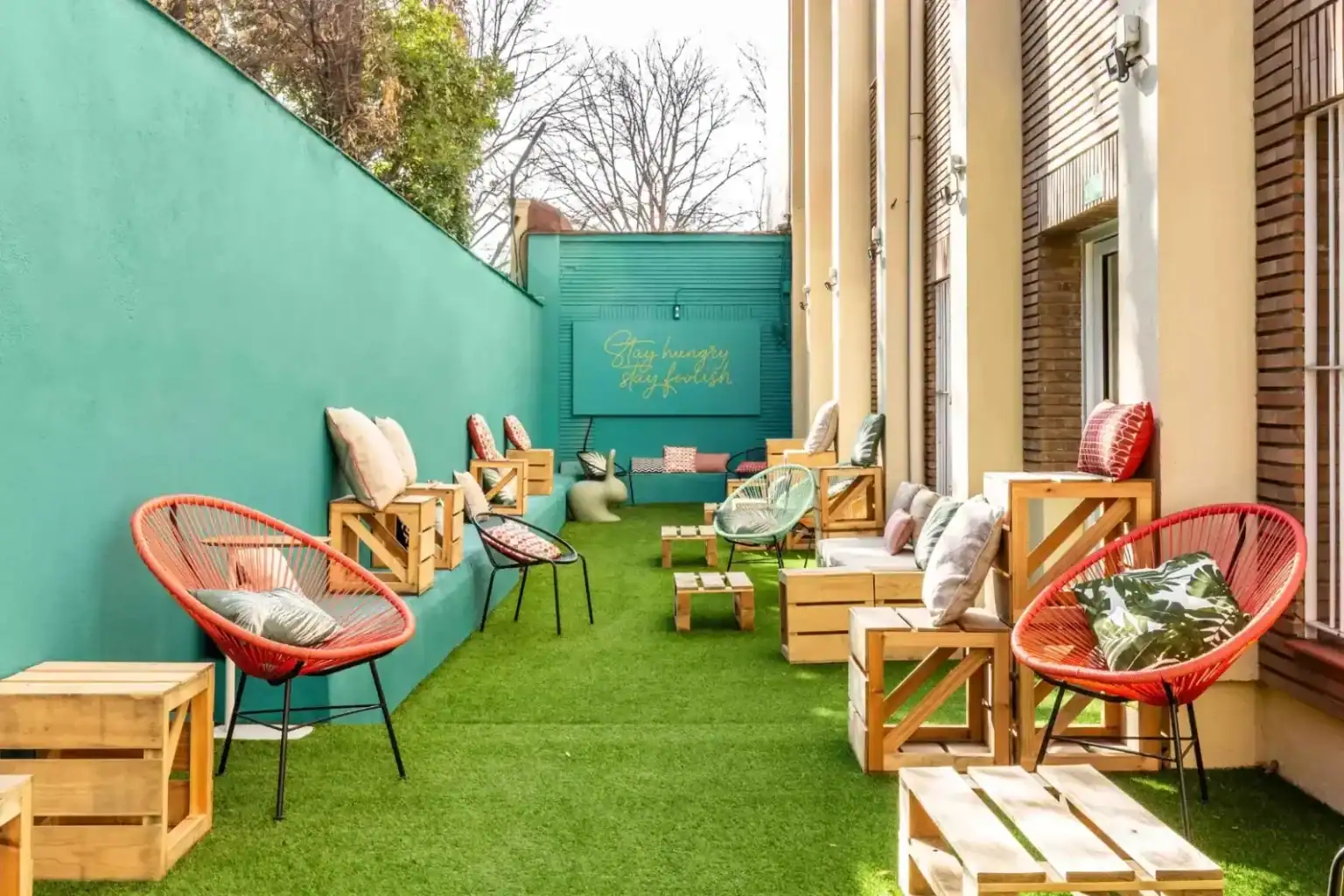 Outdoor lounge at The Global College with modern seating and vibrant decor.