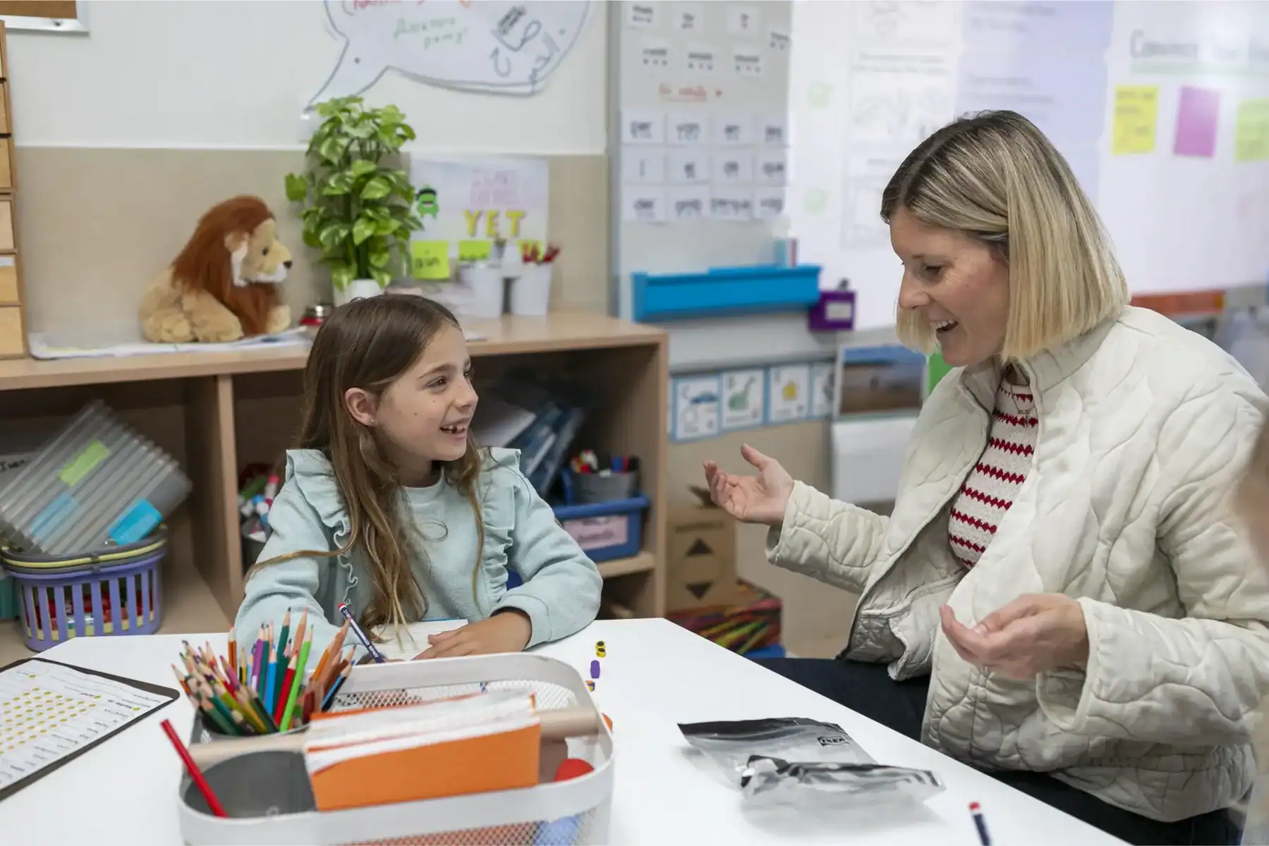 Teacher and student interaction in a classroom setting at the American School of Barcelona.