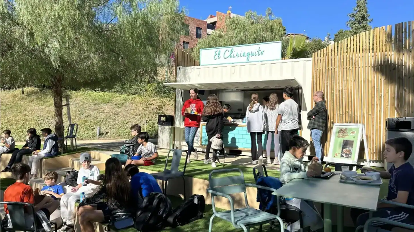 Students enjoying snacks at a food truck outside American School of Barcelona.