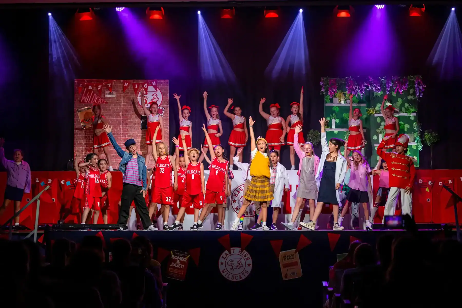Students performing on stage at American School of Barcelona event.