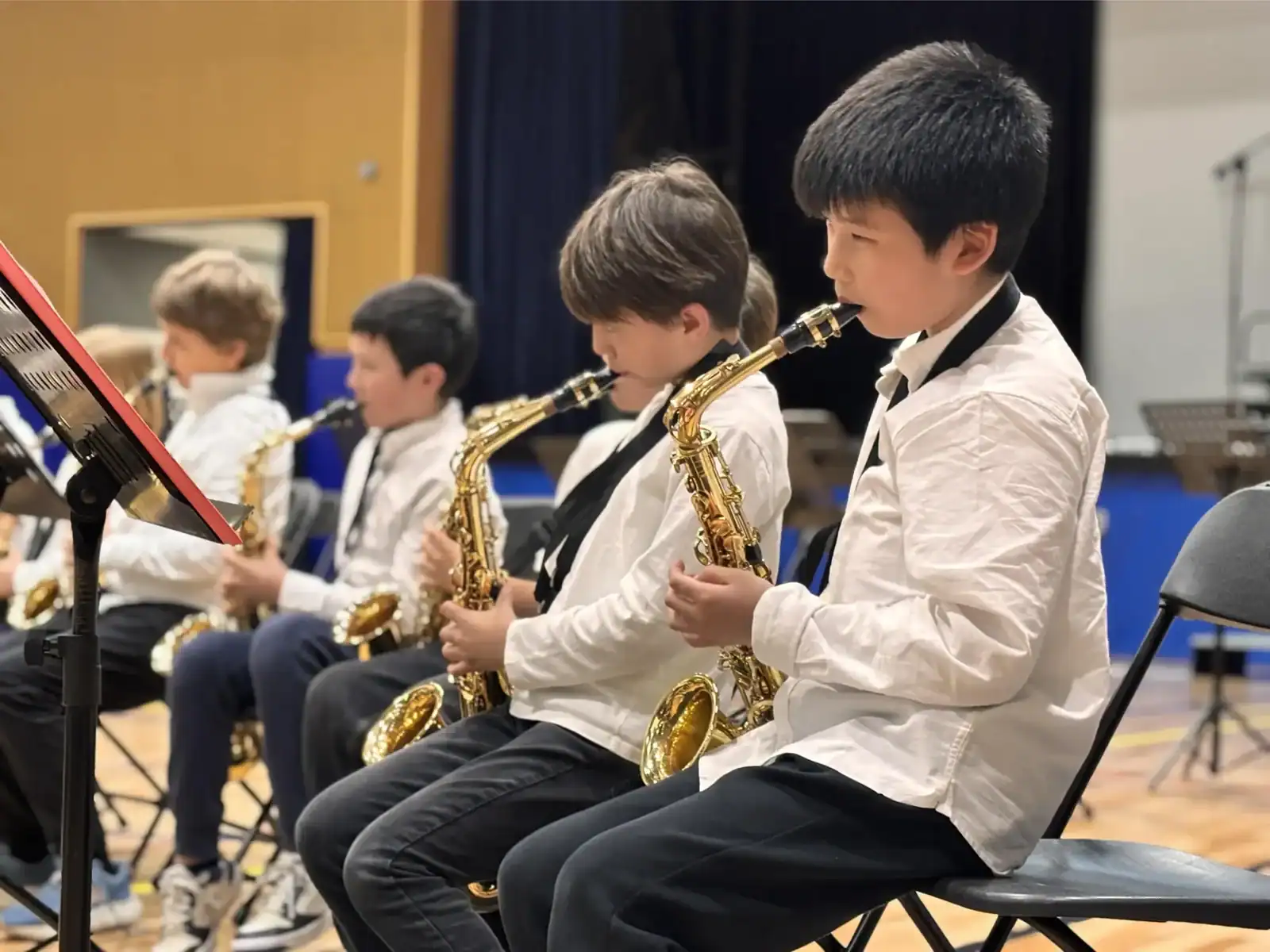 Students playing saxophones during a school music class at American School of Barcelona.