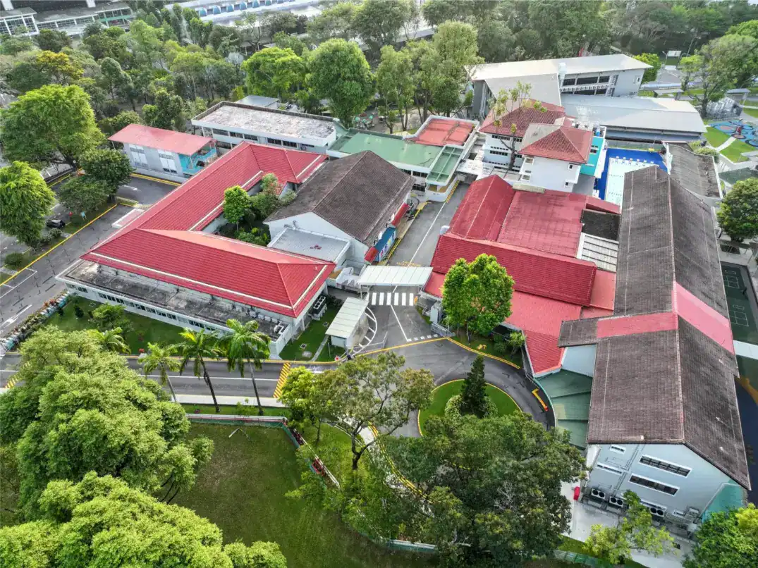 Aerial view of Dover Court International School surrounded by lush greenery and modern facilities.
