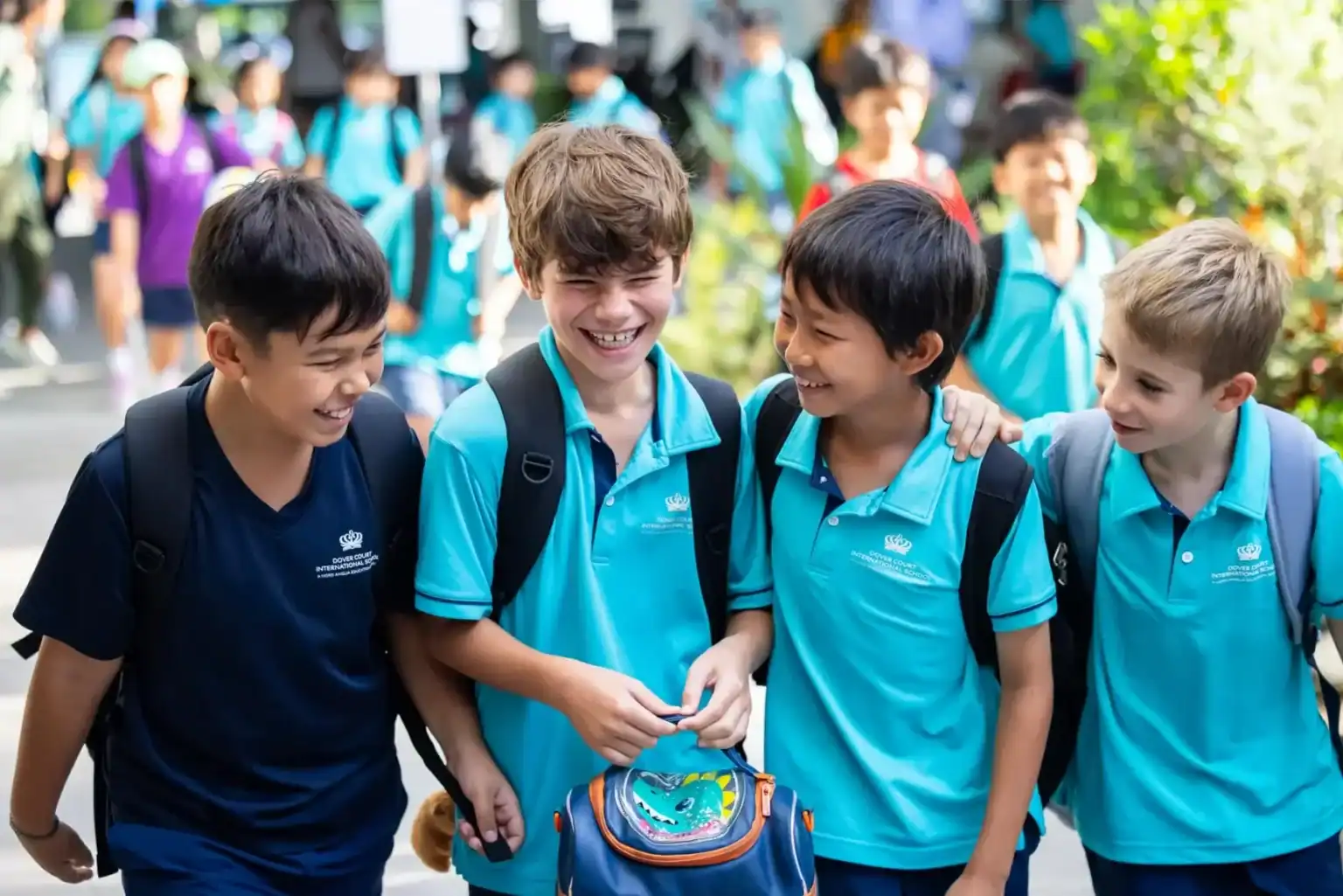 Group of diverse students smiling and chatting outdoors at Dover Court International School.