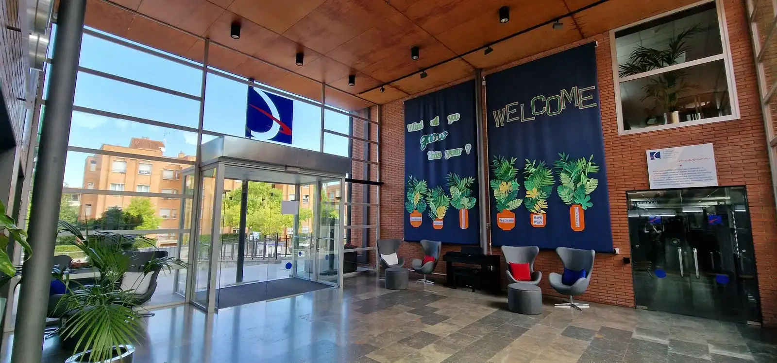 World Schools entrance with welcoming mural and plants.