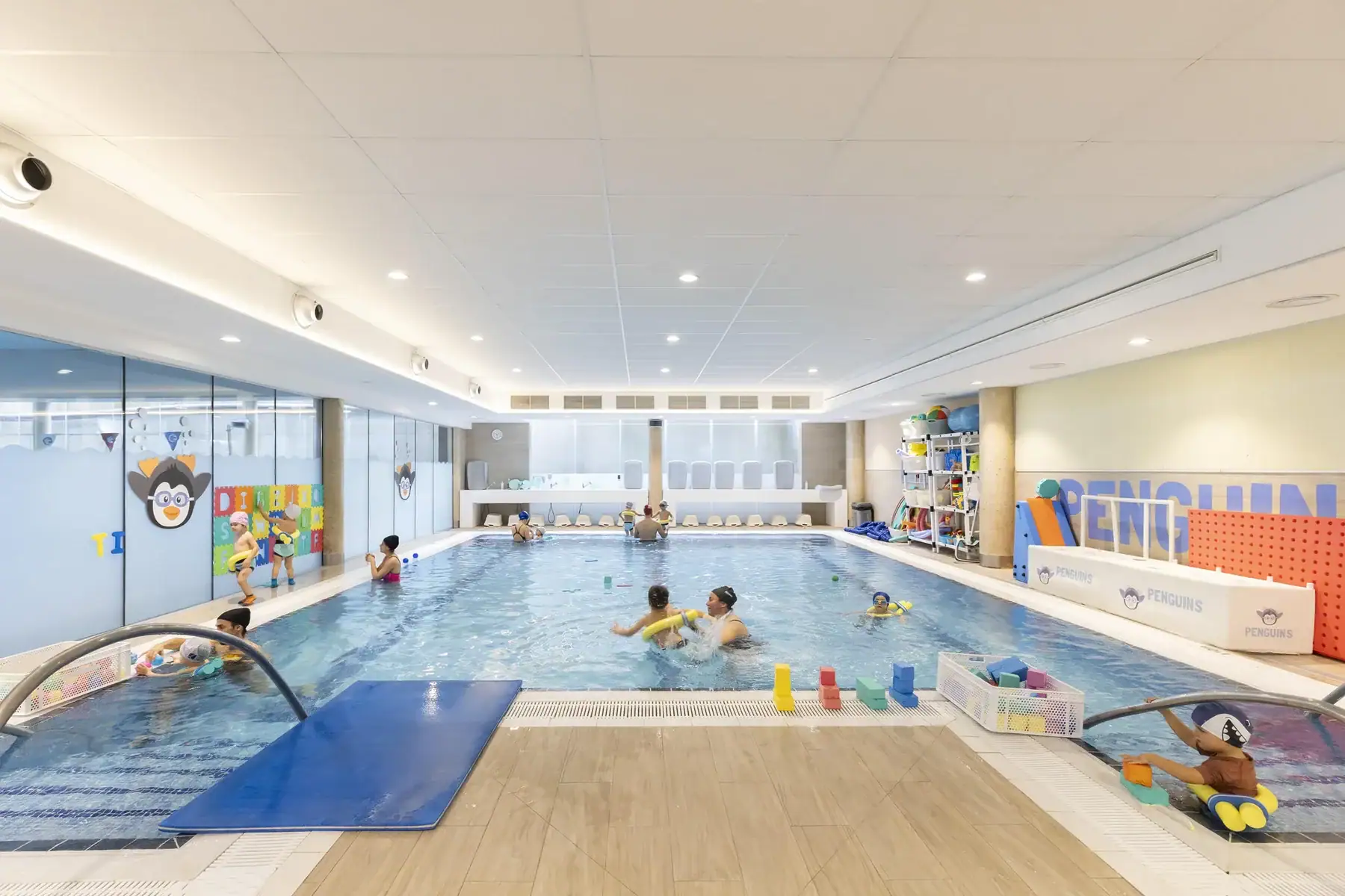 Indoor swimming pool at European International School of Barcelona with children swimming.