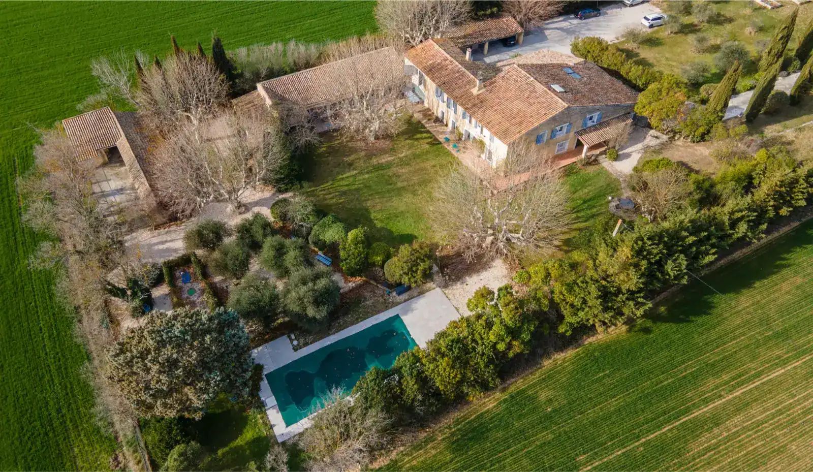 Luxurious private school with lush gardens, outdoor pool, and scenic countryside setting.