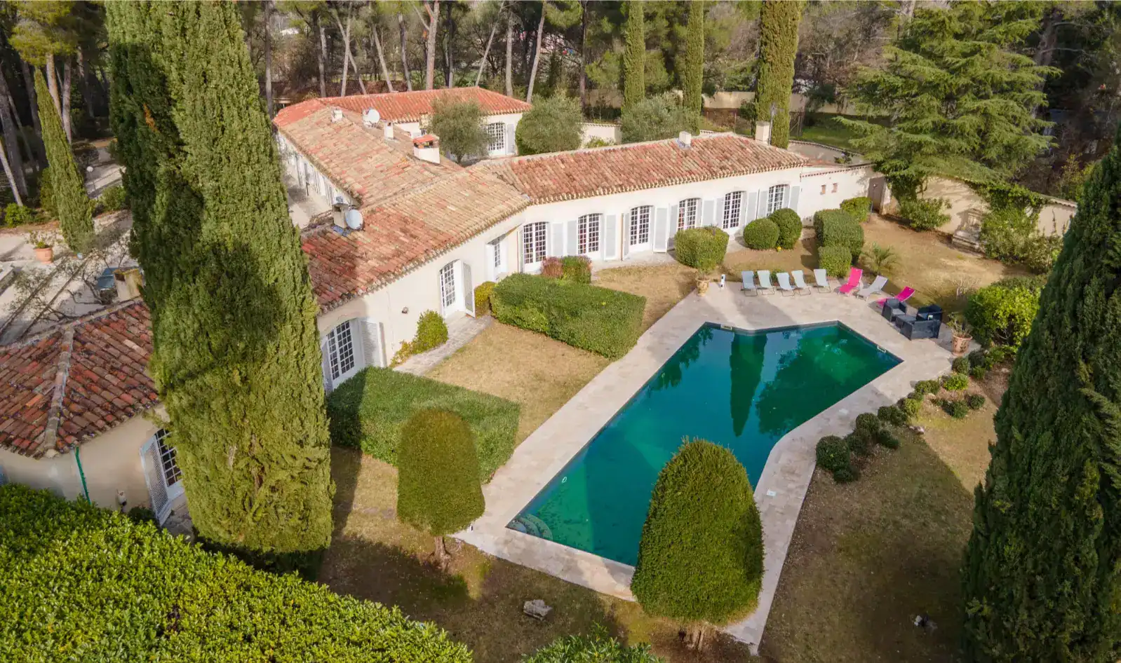 Luxurious international school with elegant architecture, outdoor pool, and lush gardens for a premium education setting.