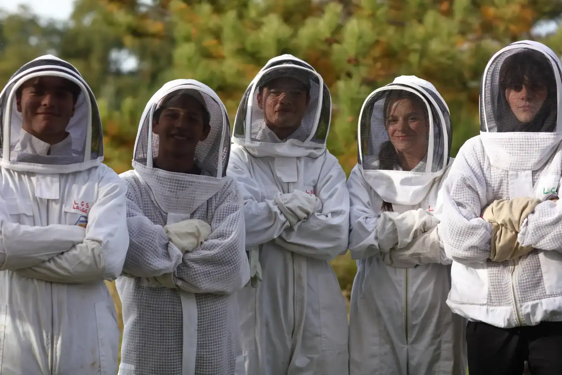 Science students wearing protective suits and masks outdoors at Lakefield College School.