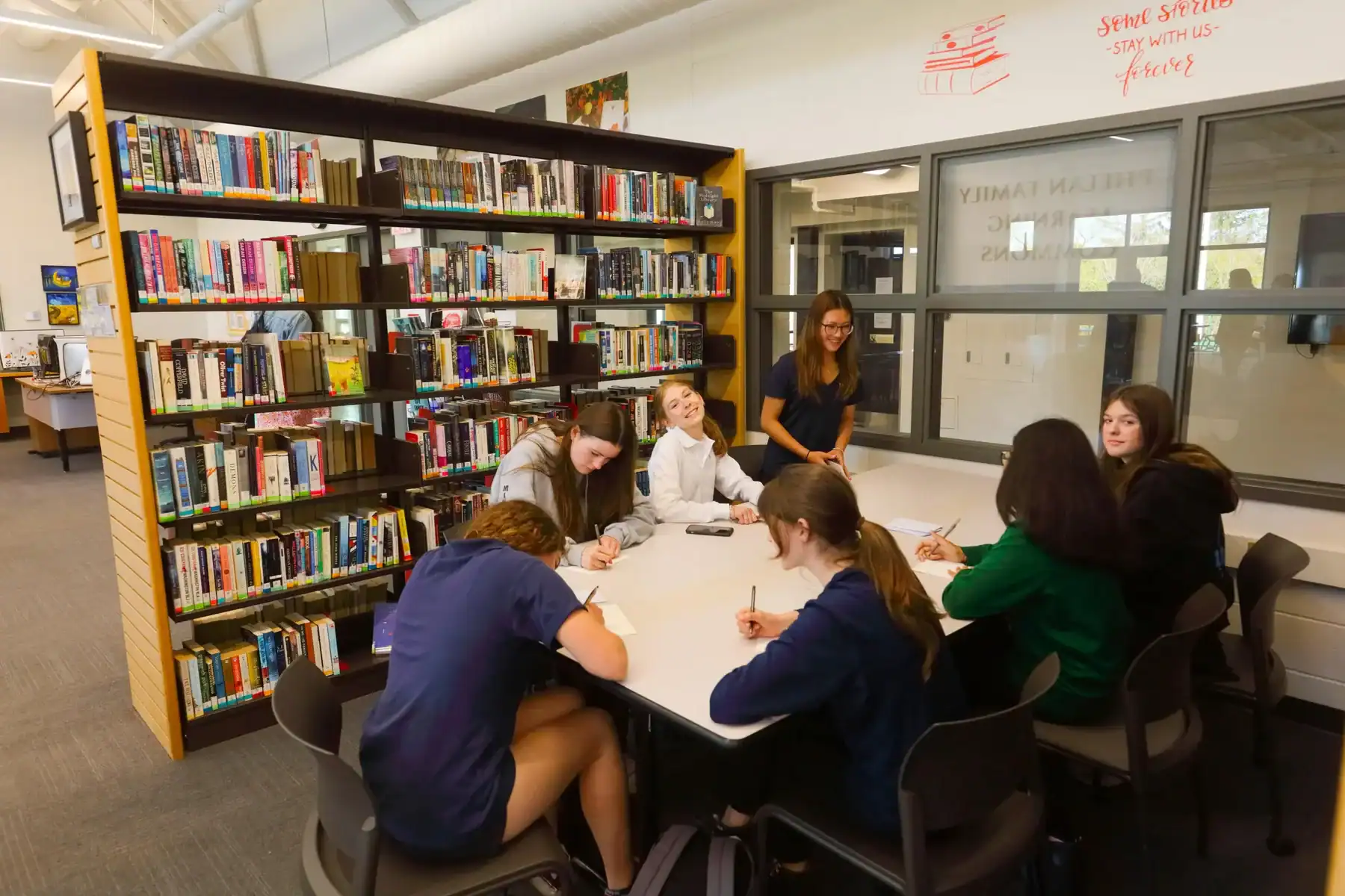 Students studying together in a library at Lakefield College School.