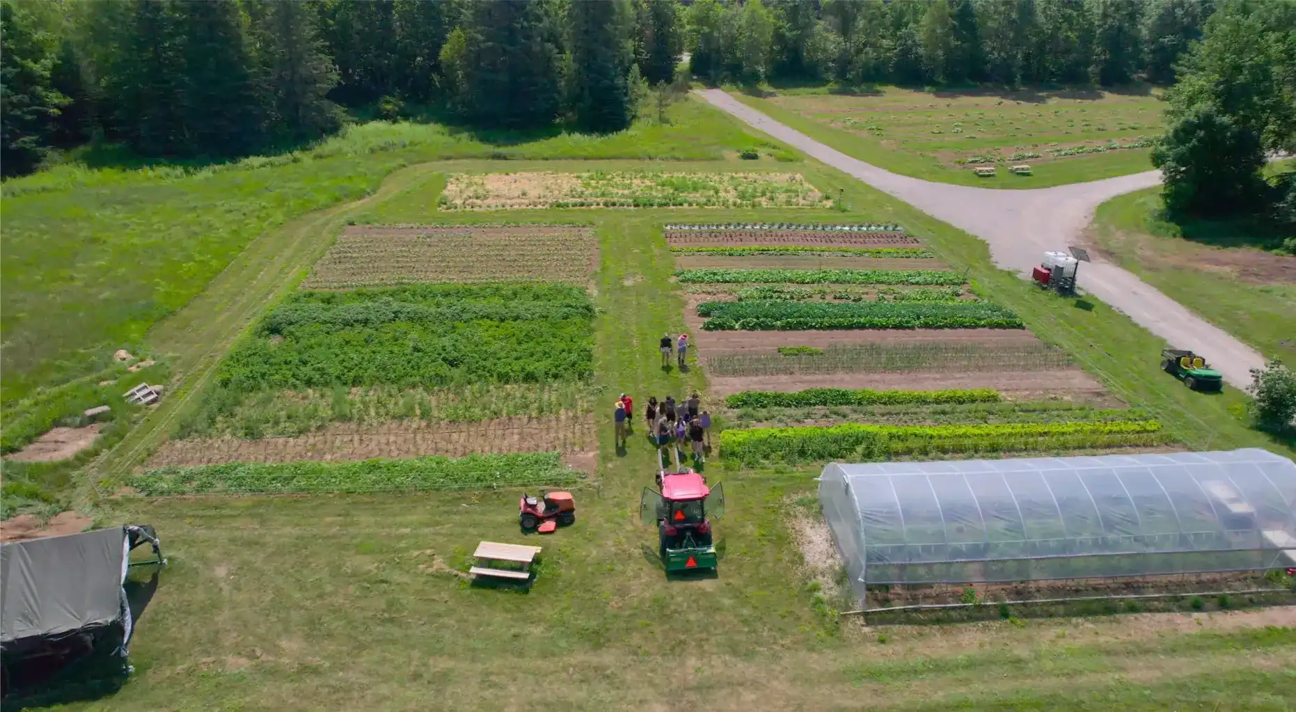 Farmers working in a vegetable garden at Lakefield College School.