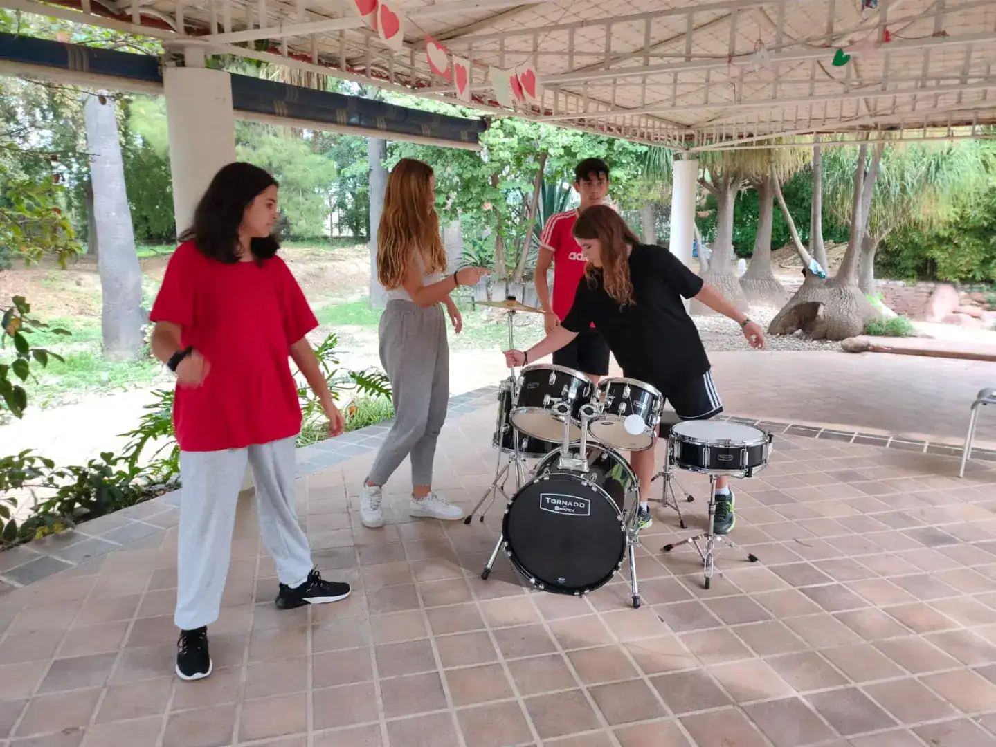 Students practicing music and band performance at an outdoor school activity.