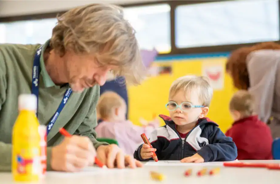 Teacher and young student engaging in a classroom activity at Thames British School - Madrid.