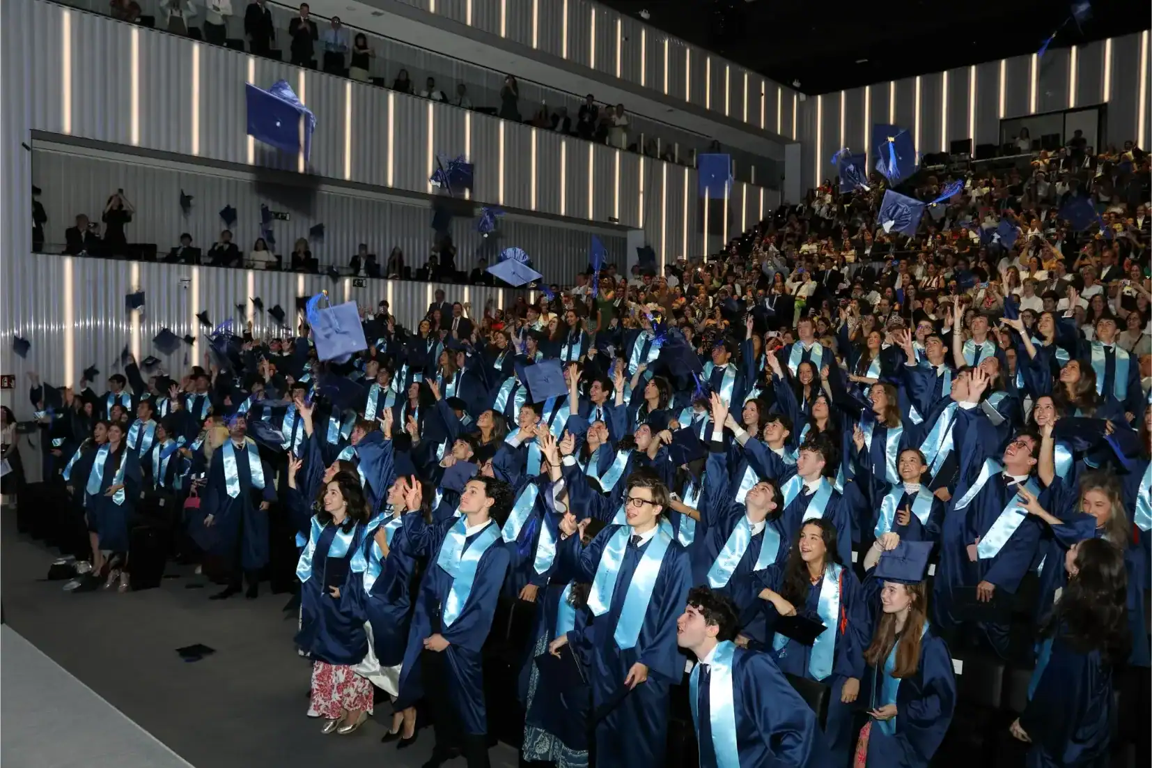 Graduates celebrating at The Global College graduation event, showcasing international students in a.