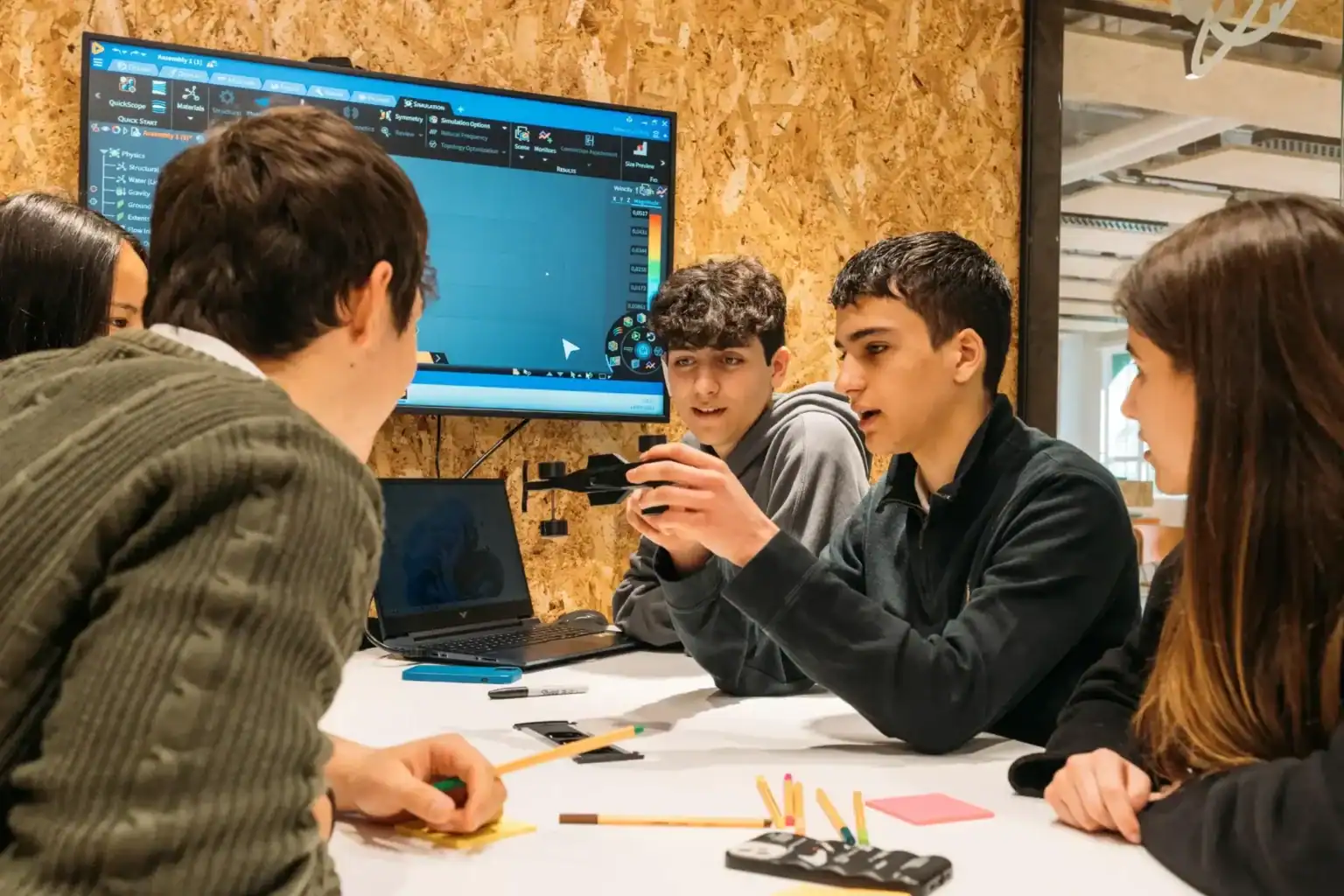 Students collaborating on digital design project at The Global College.