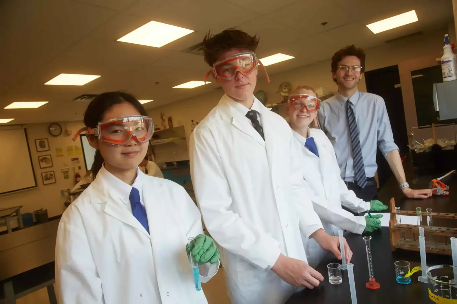Students conducting science experiments in a classroom at Trinity College School.