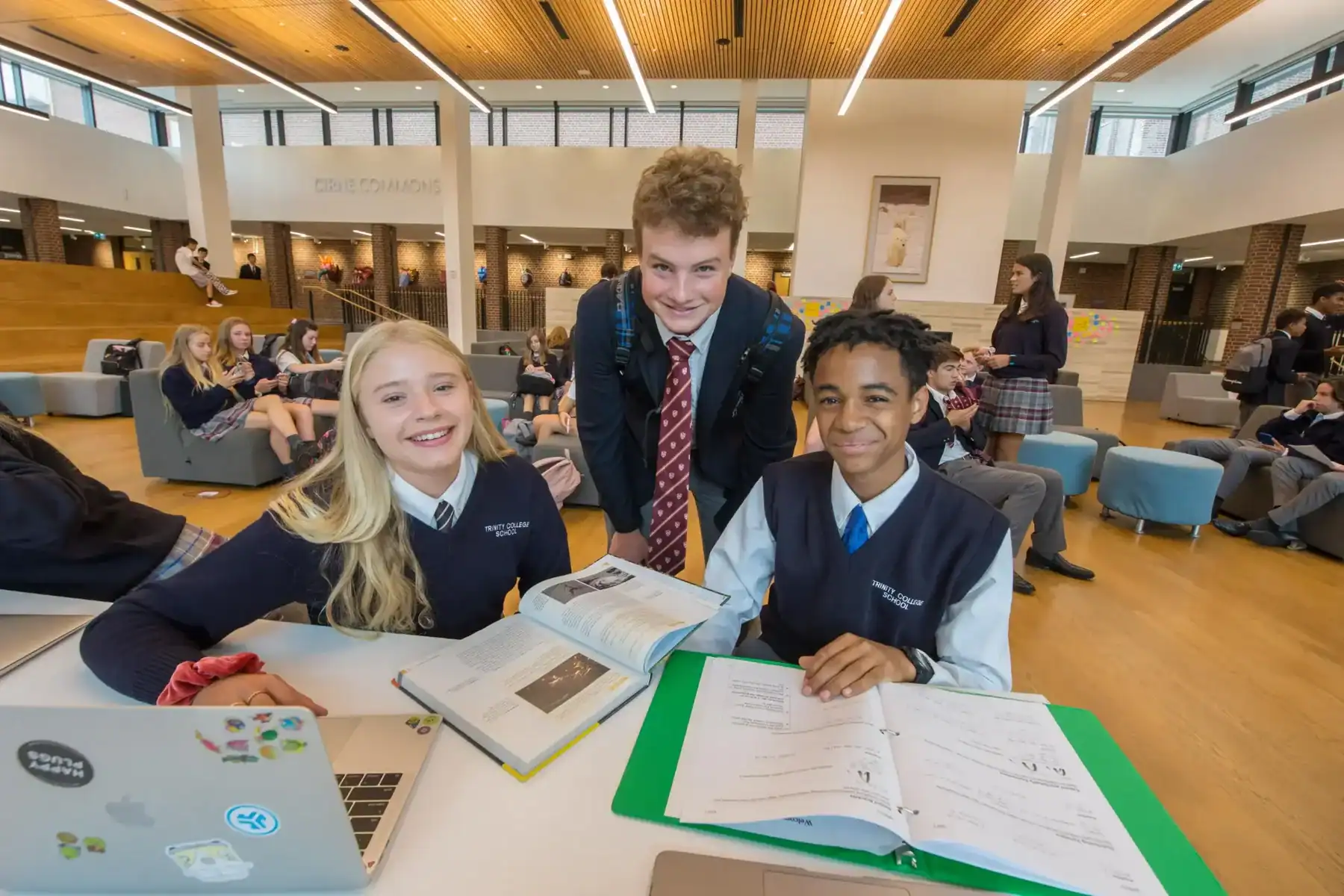 Students studying and collaborating in a modern school library.