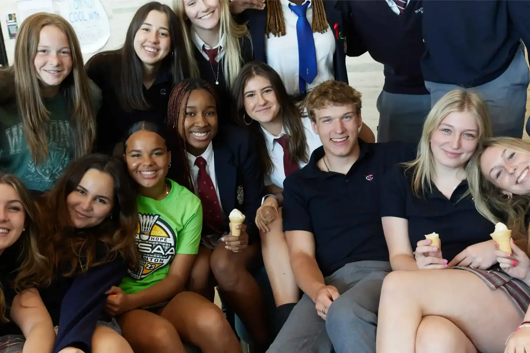 Group of diverse students enjoying ice cream at school event.