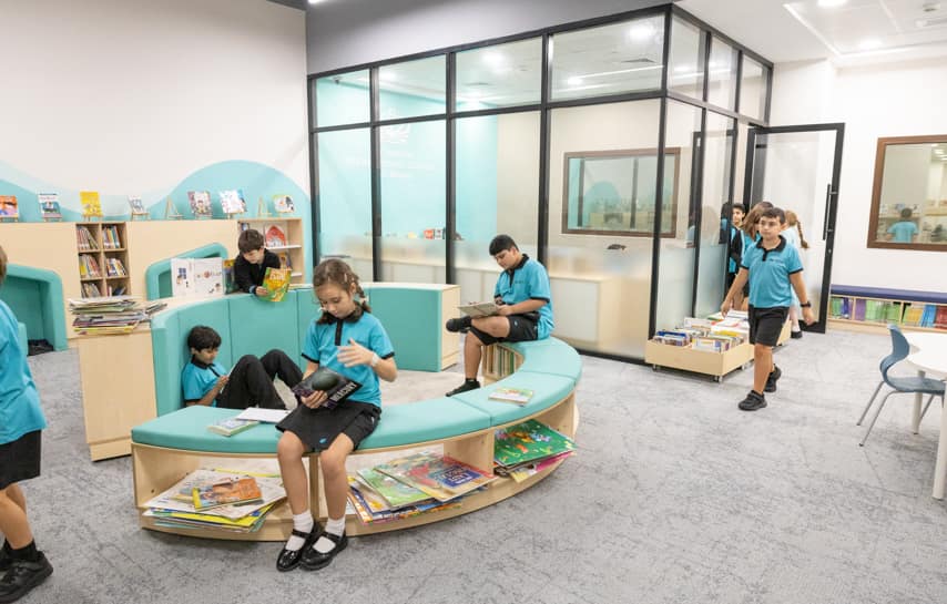 Children studying and reading in a modern school library, fostering learning and literacy skills.