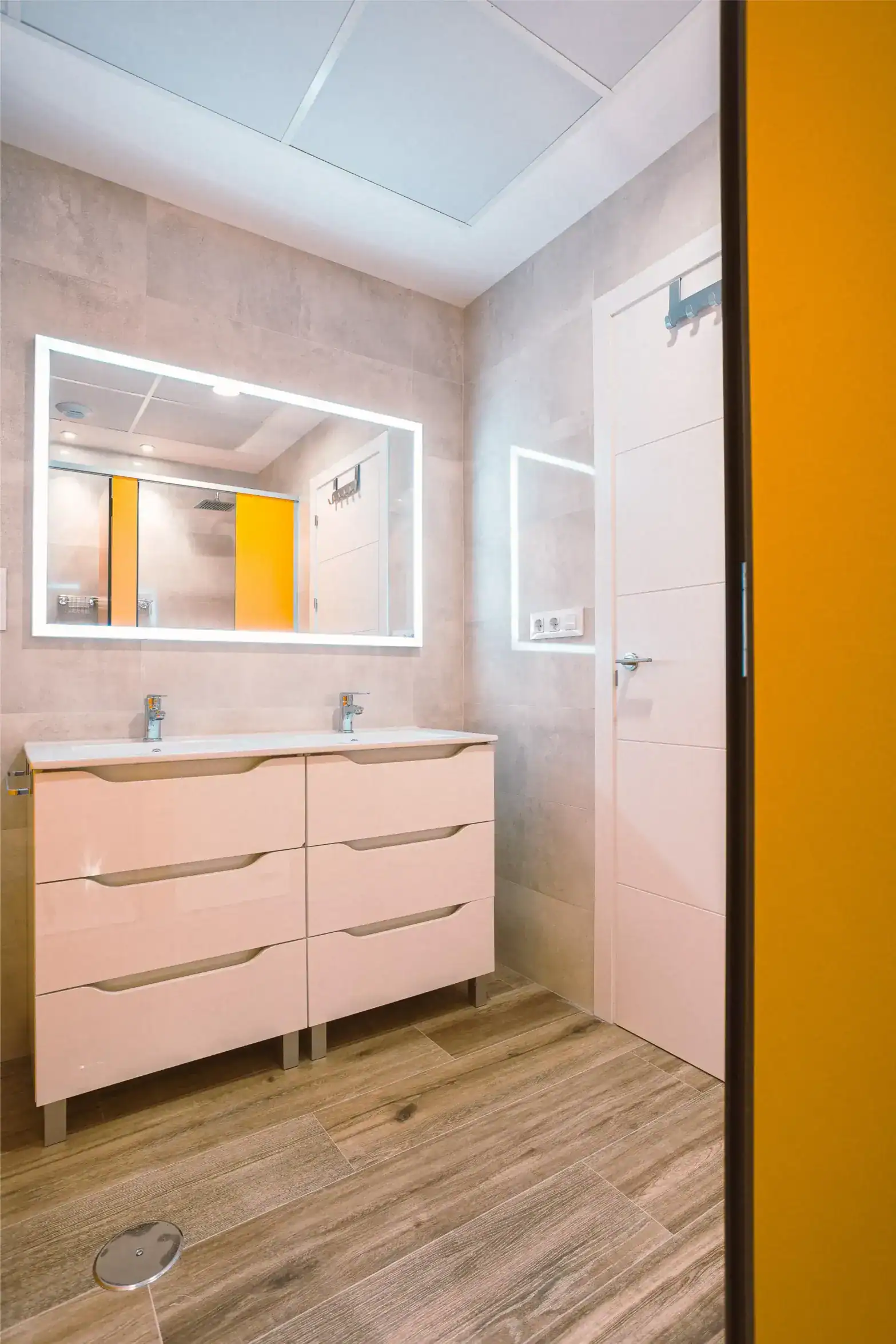 Modern school restroom with double sinks and bright lighting, ideal for student comfort and hygiene.