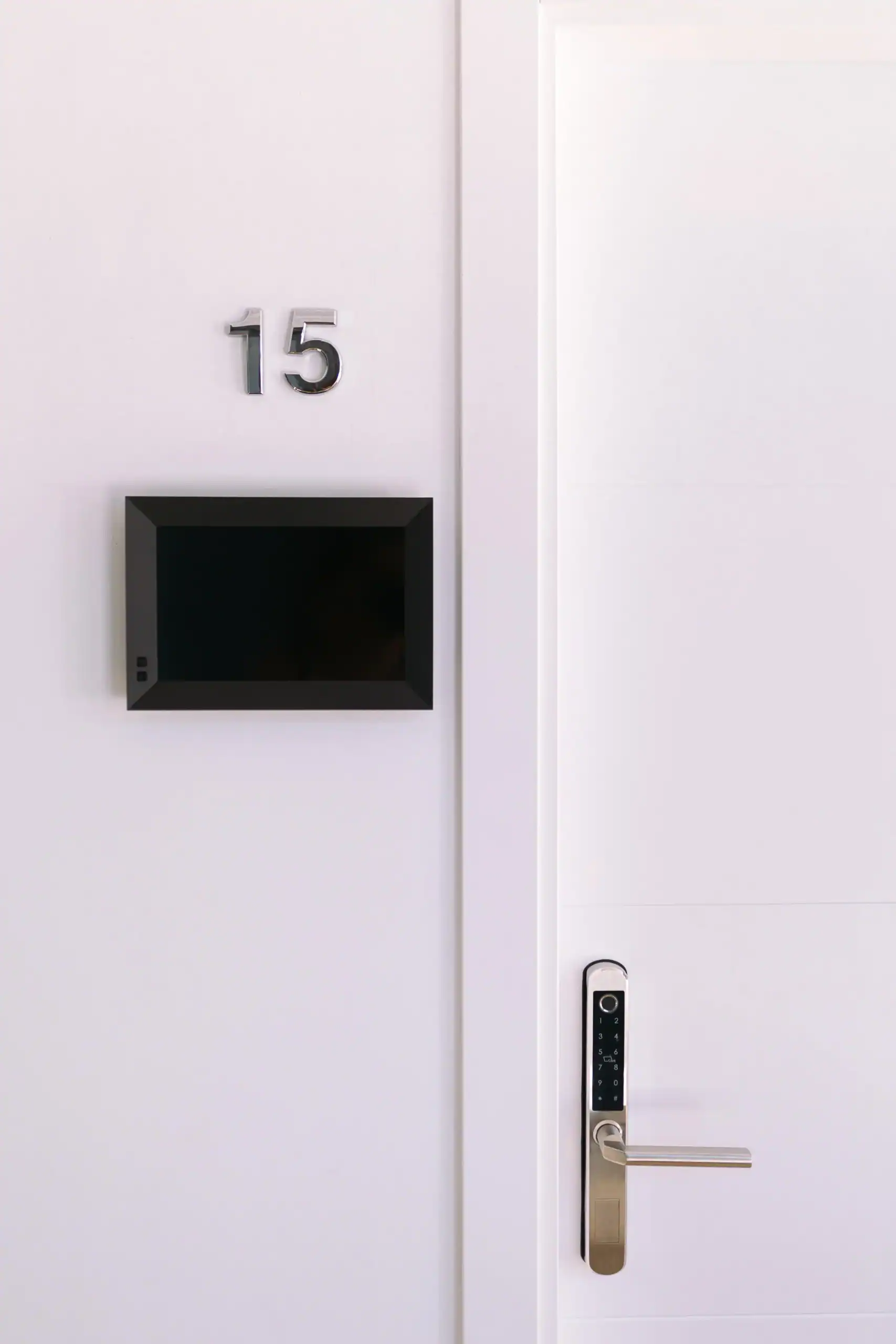 Modern classroom door with digital lock and room number 15.