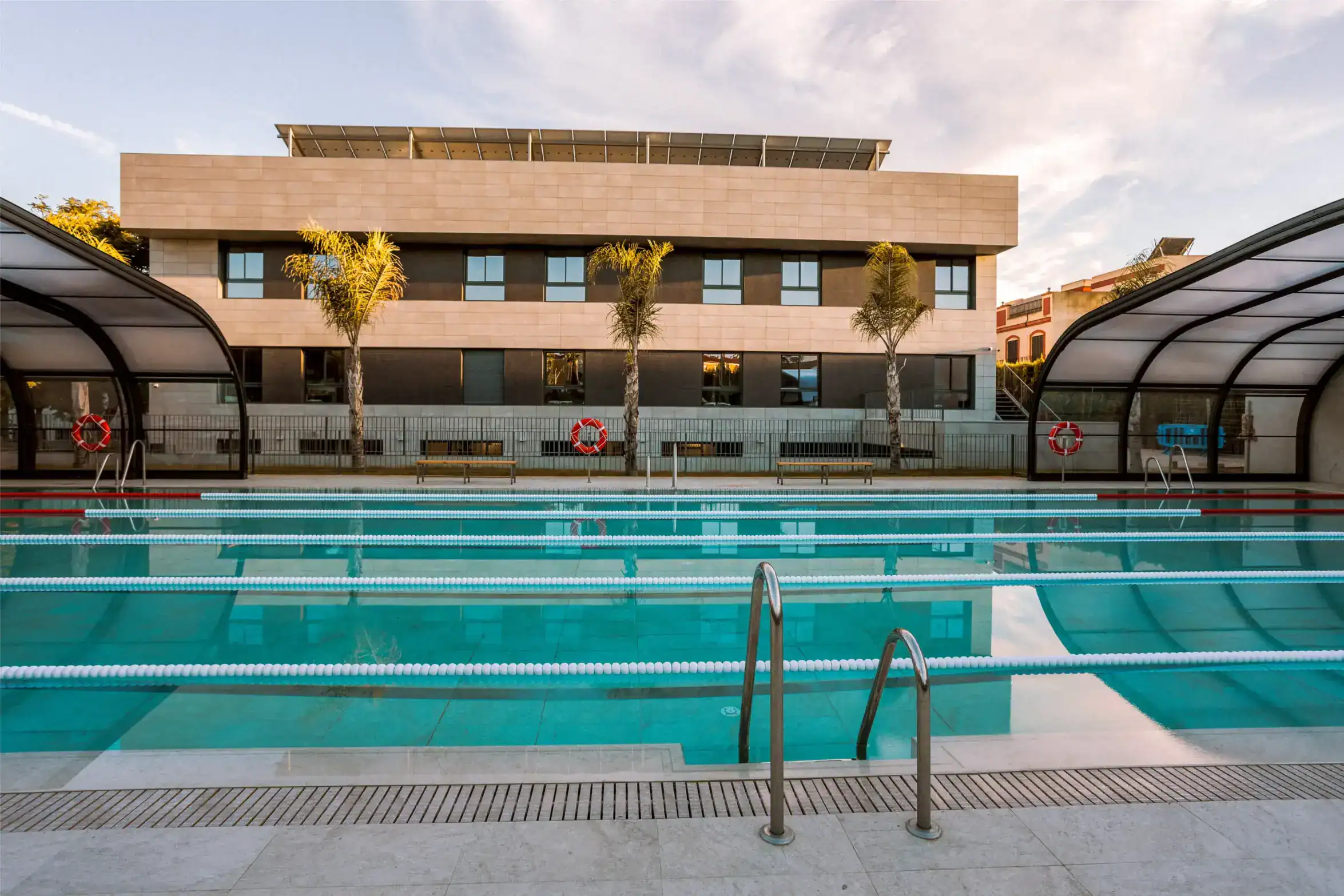 Modern school with outdoor swimming pool and recreational facilities for students.