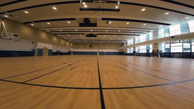 Indoor basketball court at Dwight School Hanoi sports facility.