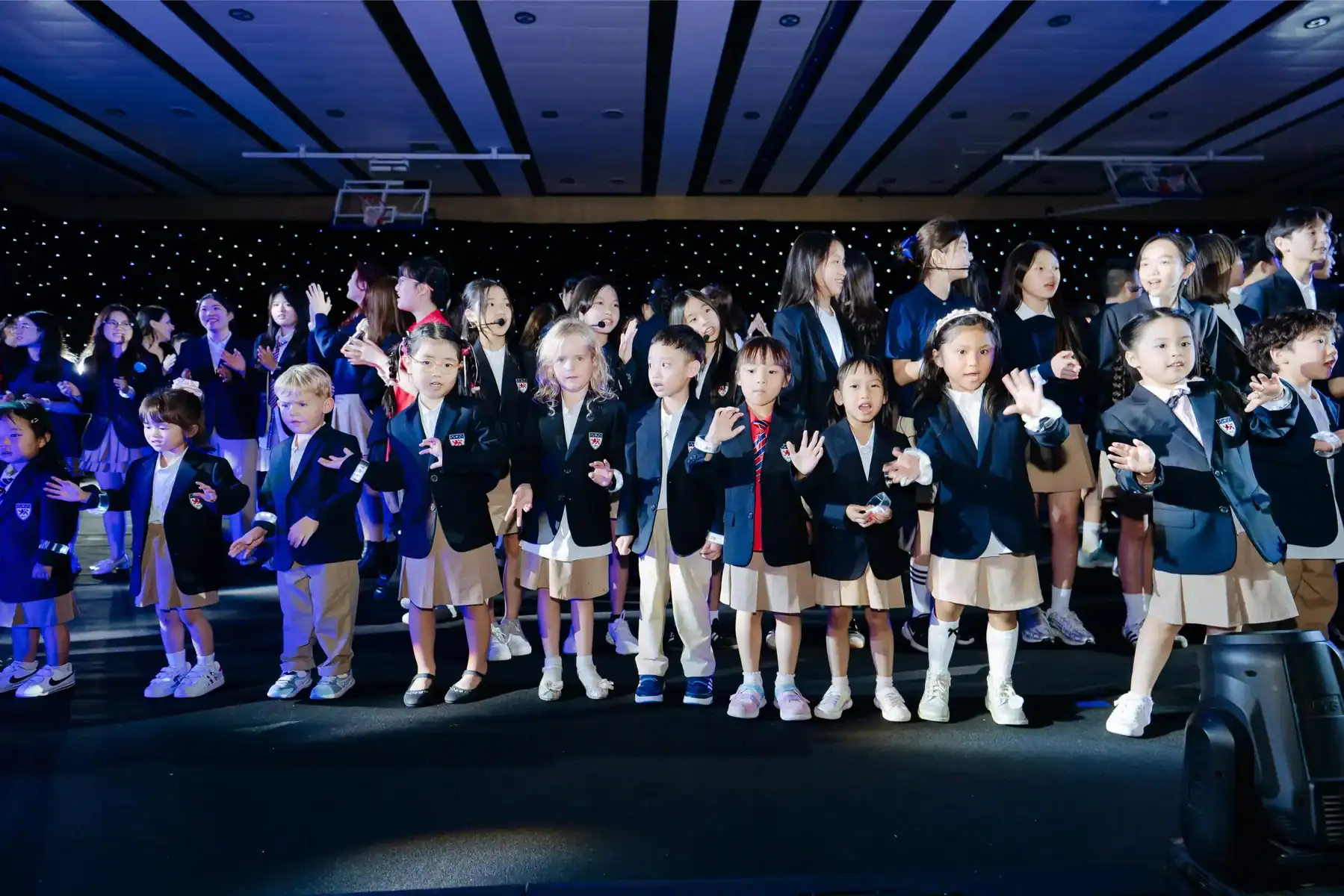 Dwight School Hanoi students performing on stage at a school event.