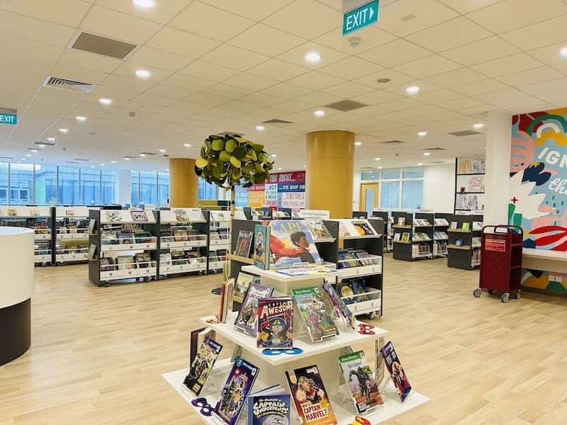Modern library at Dwight School Hanoi with bookshelves and colorful decor.