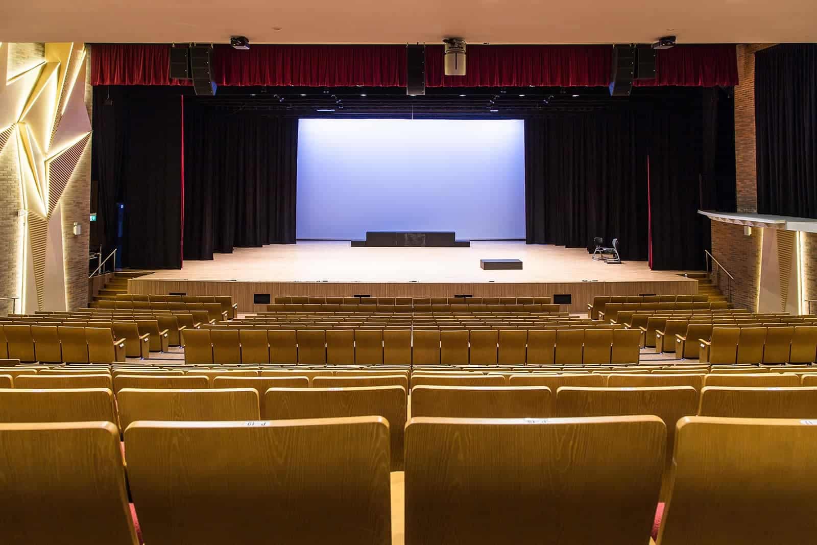 Auditorium at Dulwich College Shanghai Pudong with stage and seating for school activities.