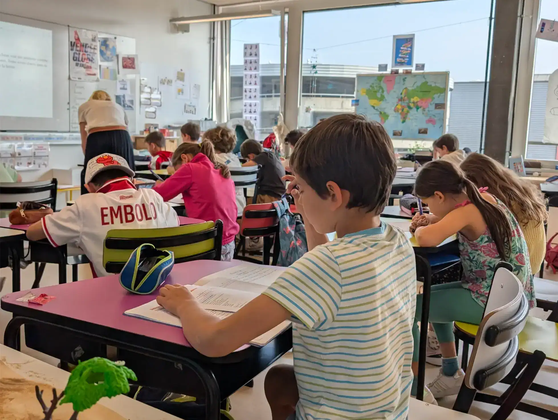 Modern international classroom with diverse students studying and engaging in learning activities.