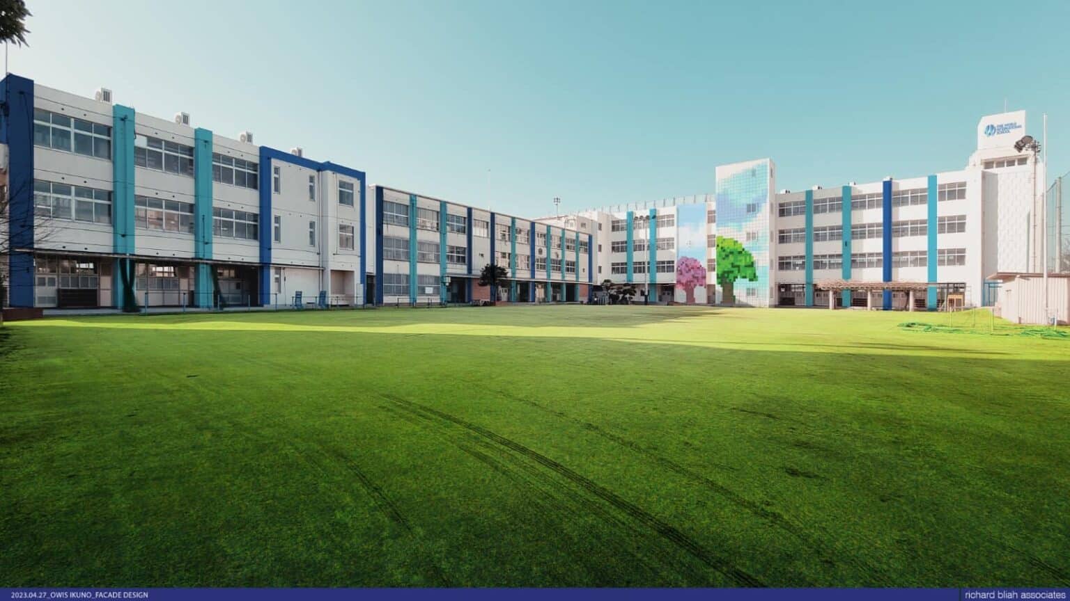 Bright modern school building with colorful facade and open green field, ideal for learning and recreation.