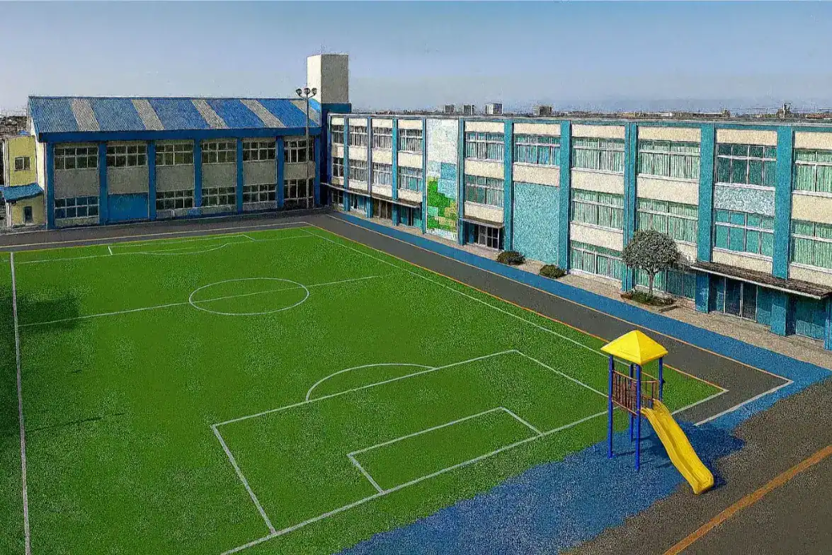 Bright blue school building with a playground sports field and slide, ideal for sports and outdoor activities.