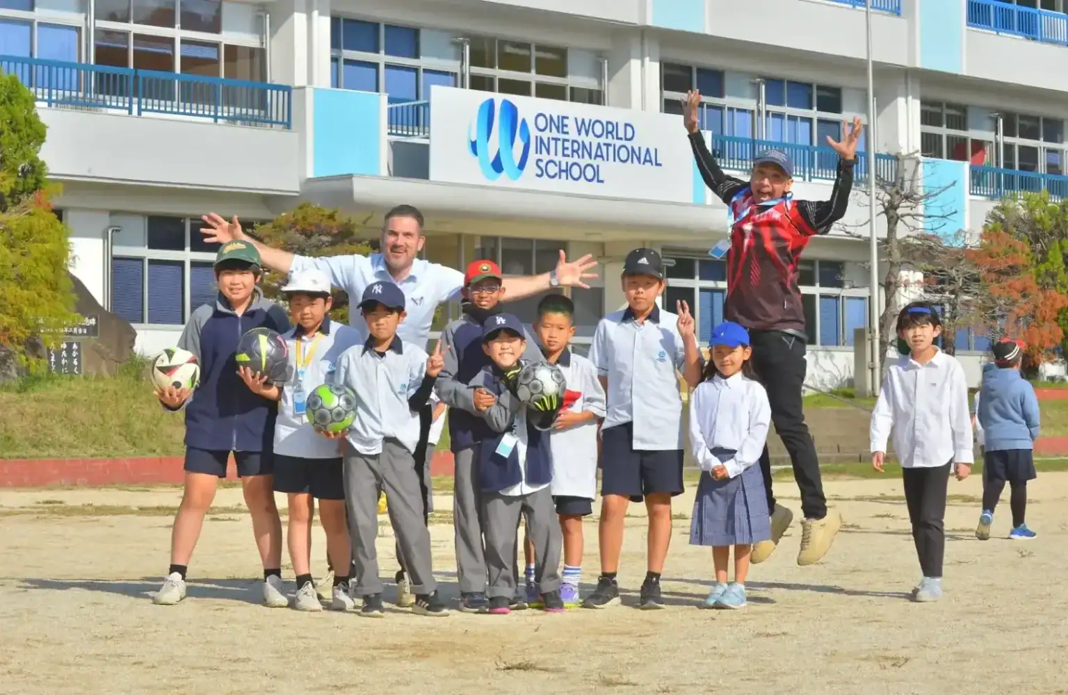 Soccer-playing children at One World International School campus, engaging in sports and outdoor activities.