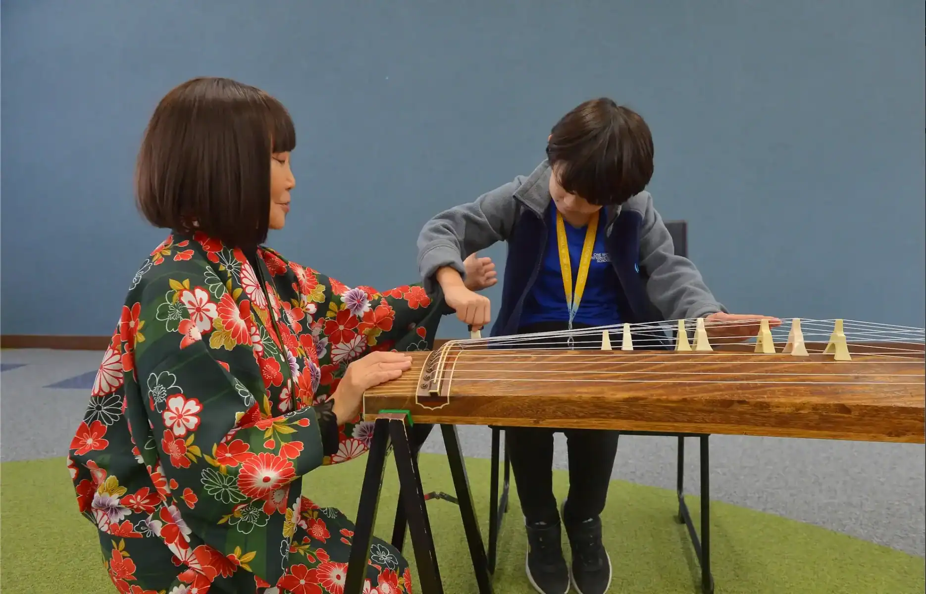 Traditional Japanese koto music lesson with teacher and student at World Schools.