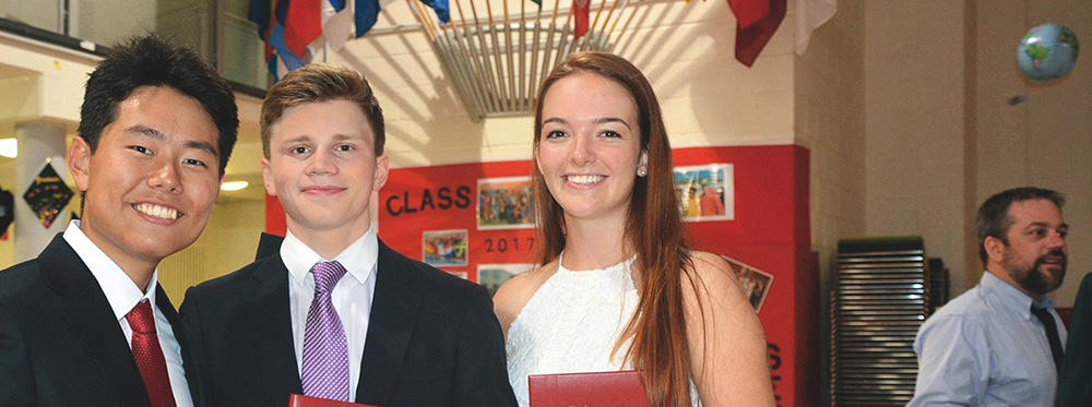 Diverse students celebrating graduation at World Schools with diploma, symbolizing academic excellence and international education.
