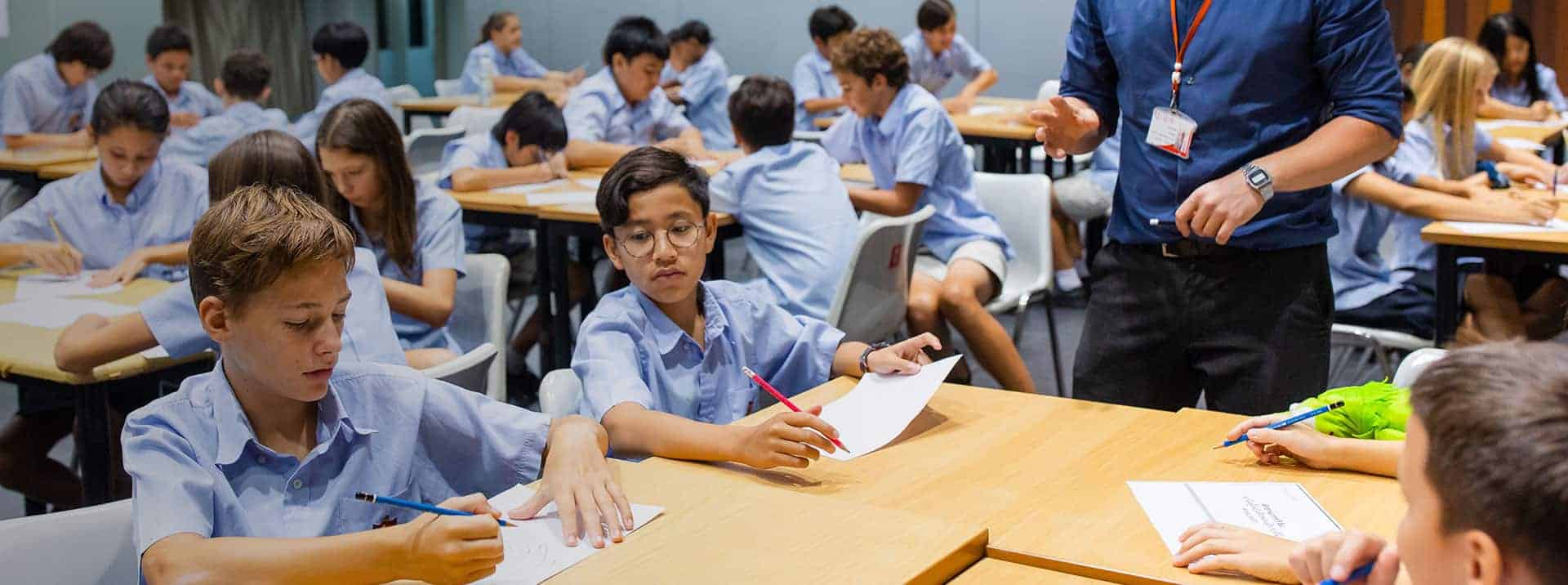 Highly focused students engaged in classroom activities at a prestigious world school, fostering academic excellence.