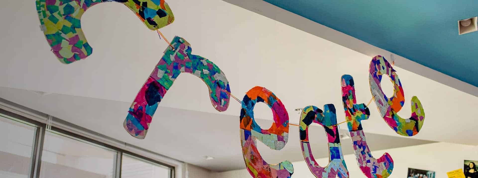 Colorful "Welcome" sign hanging indoors at World Schools, promoting a friendly learning environment.