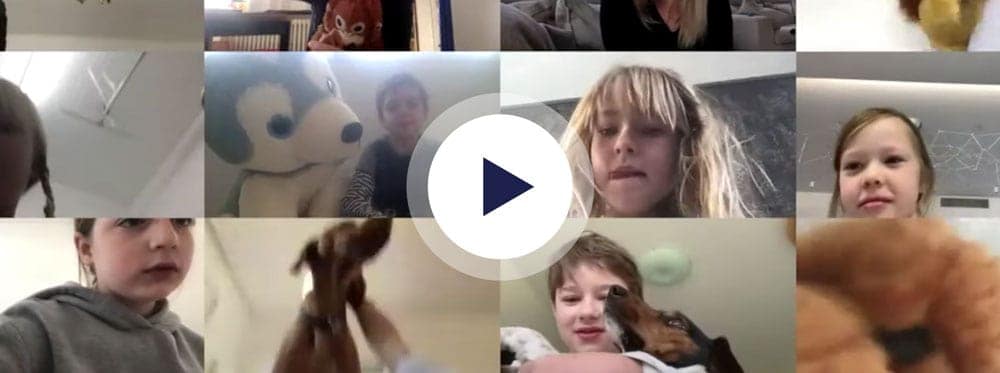 Happy children and pets at a World Schools online learning session in a classroom setting.