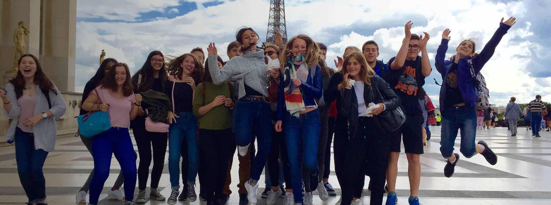 Bright group of diverse students enjoying a field trip at a world school campus.
