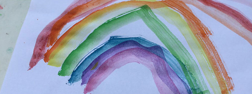 Vibrant watercolor rainbow artwork symbolizing diversity and creativity in international schools.