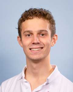 Latest news from TASIS - October, 2022 4 Highly educated young professional smiling in a professional setting.