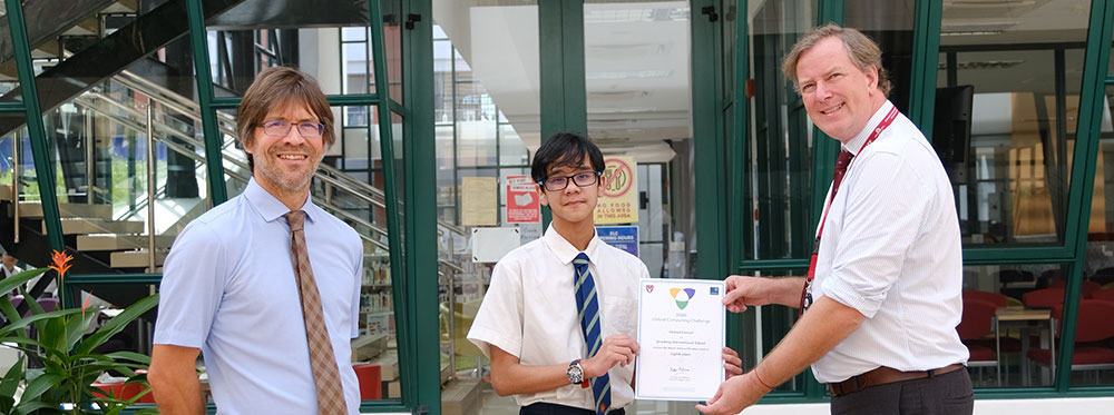 Dedicated international school achievement recognition in front of glass building, emphasizing world-class education.