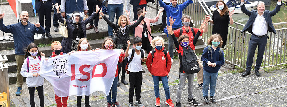 Welcoming group of diverse students and staff at World Schools, promoting international education and global community.